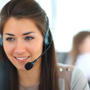 Female customer support operator with headset and smiling